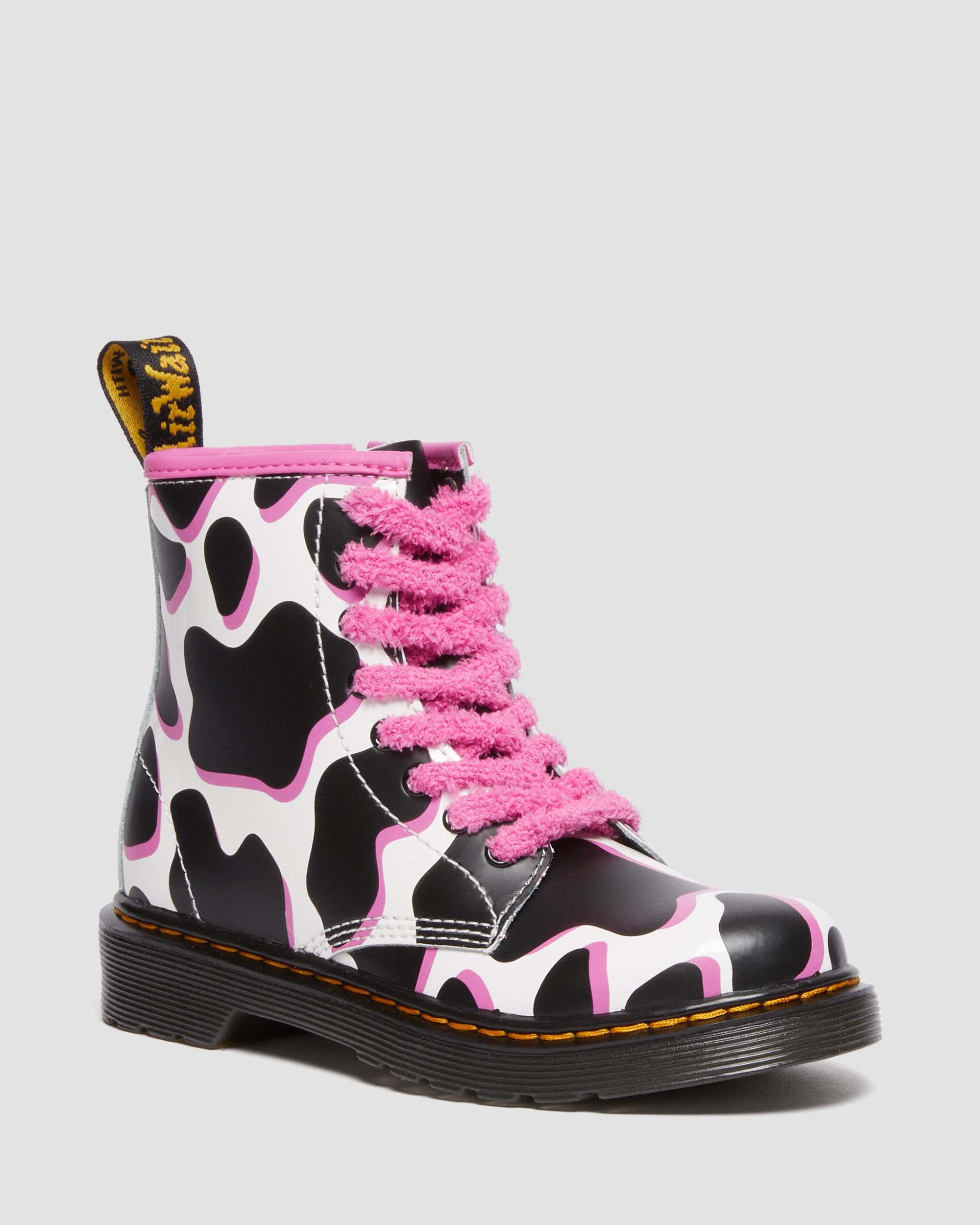 Junior 1460 Cow Print Patent Leather Lace Up Boots in White | Dr. Martens