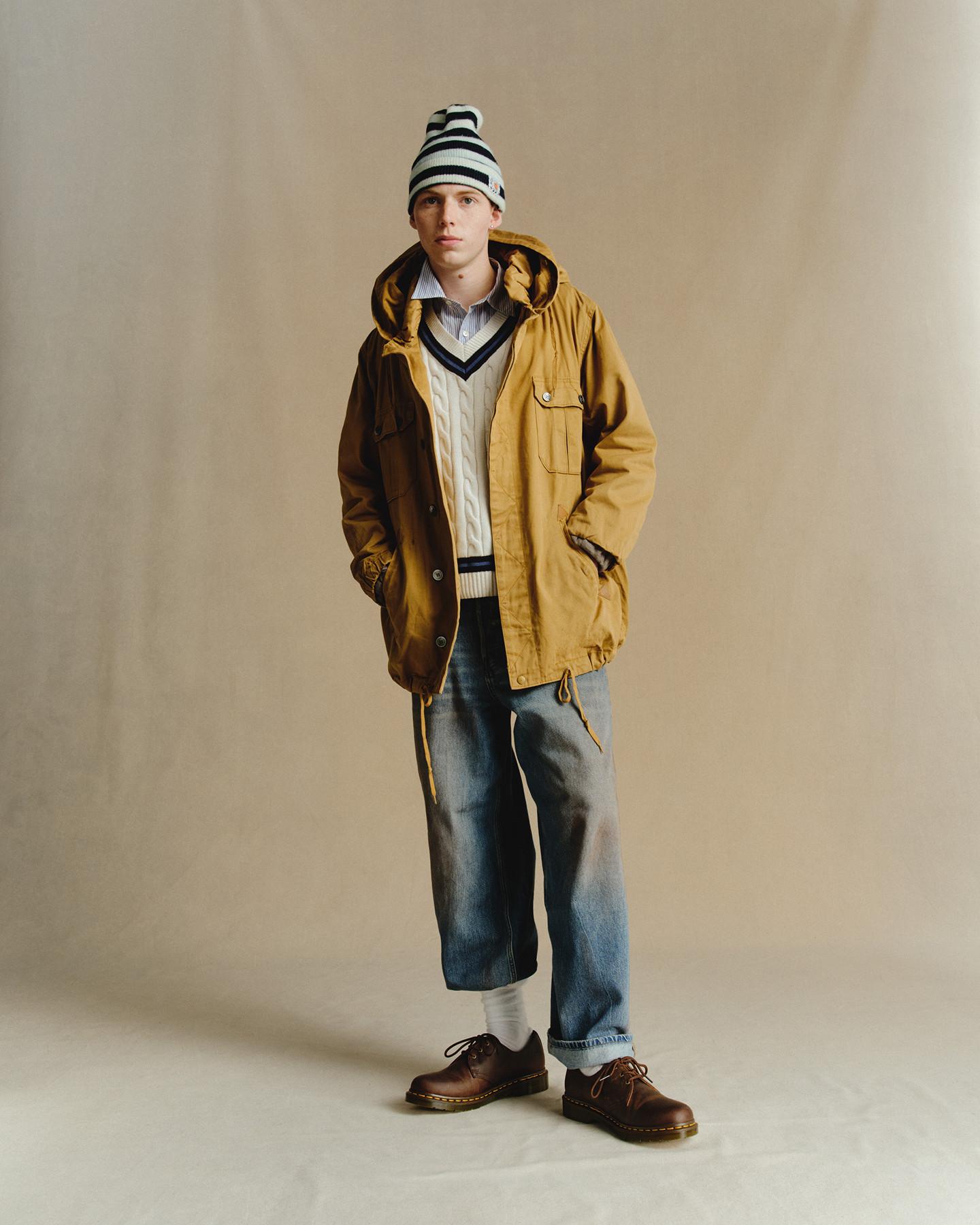 Brown leather shoes with yellow stitching, worn with cuffed jeans and white socks