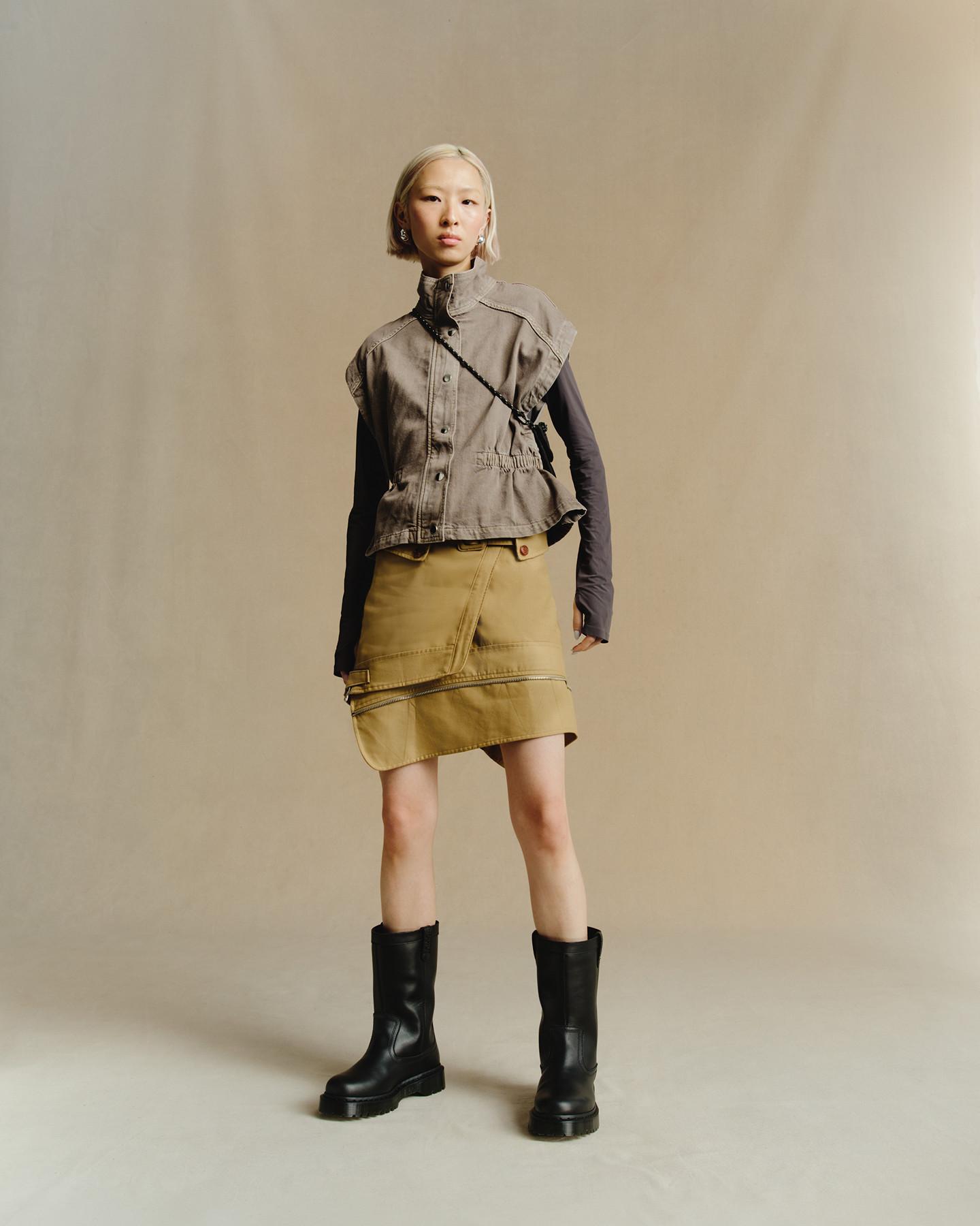 Black leather mid-calf boots with a chunky sole, worn with a utility skirt