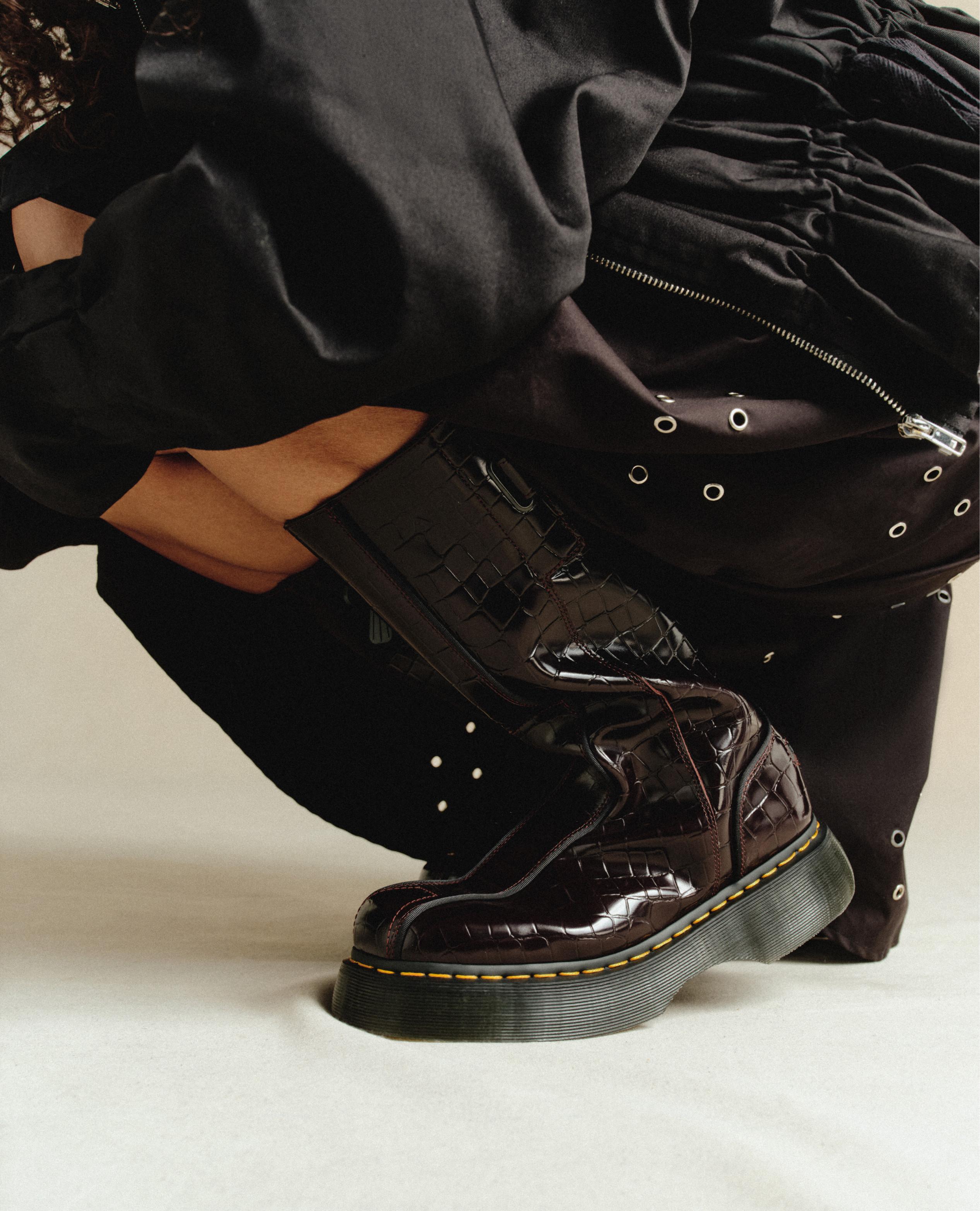 Dark burgundy croc-embossed leather platform boots with yellow welt stitching