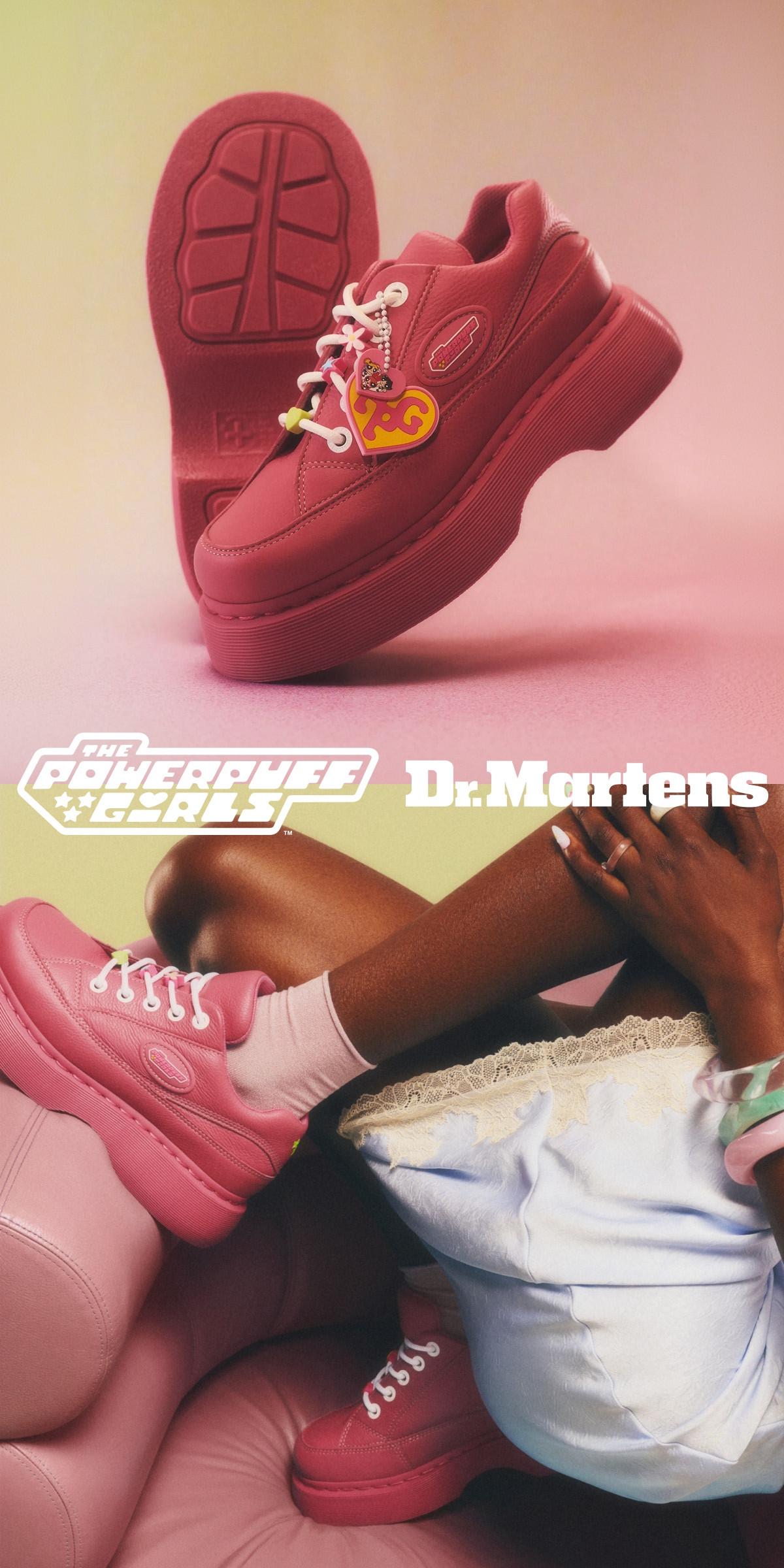 Pink leather low-top trainers with white laces and heart charm, worn with pale pink socks
