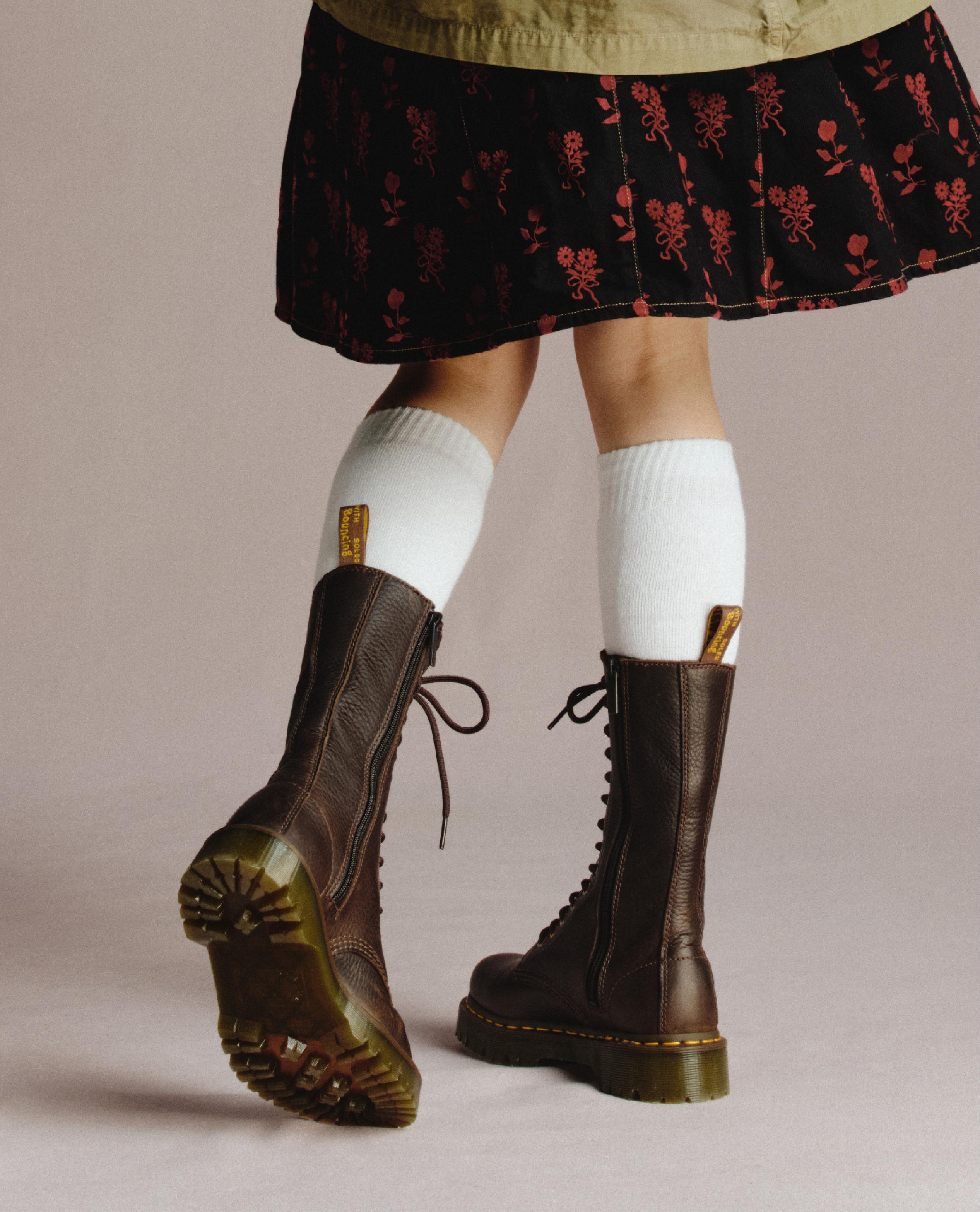 Brown leather lace-up boots with side zip, worn with white knee socks and floral skirt