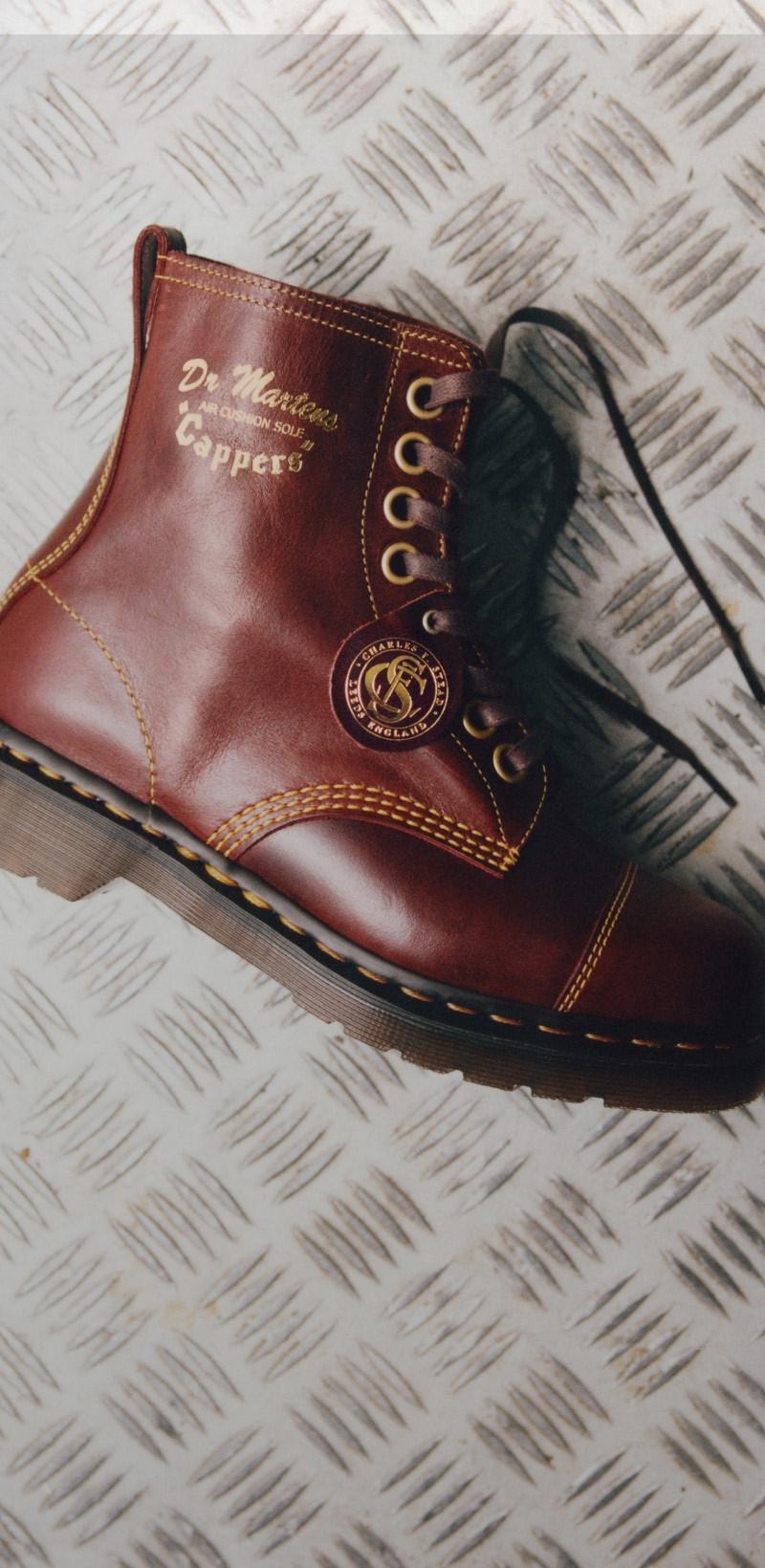 Oxblood leather lace-up boot with contrast yellow stitching on a silver tread-plate floor