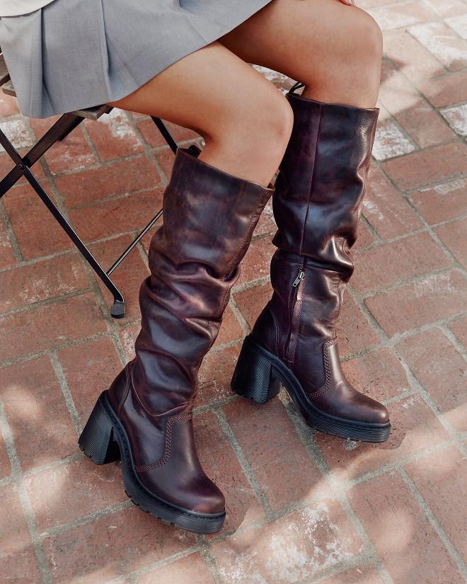Burgundy leather knee-high boots with ruched shafts, side zip and chunky black heel