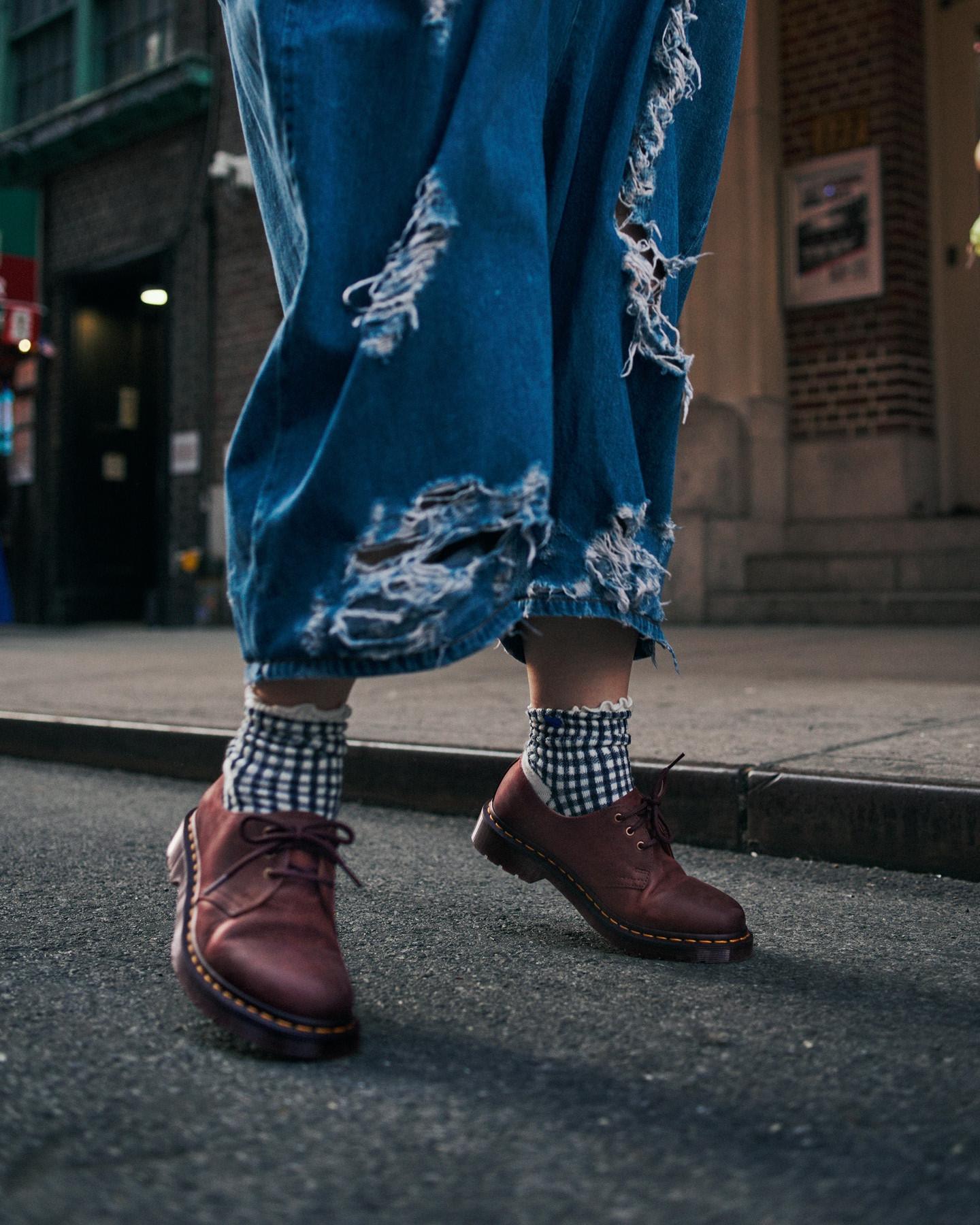 Cherry red leather 3-eye shoes with yellow welt stitching, worn with gingham socks