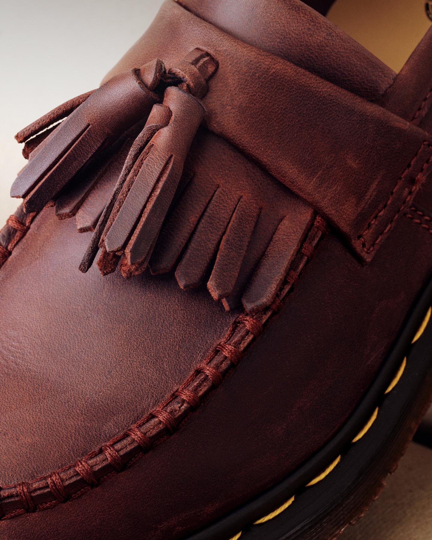 Close-up of oxblood leather loafer with kiltie fringe and tassels