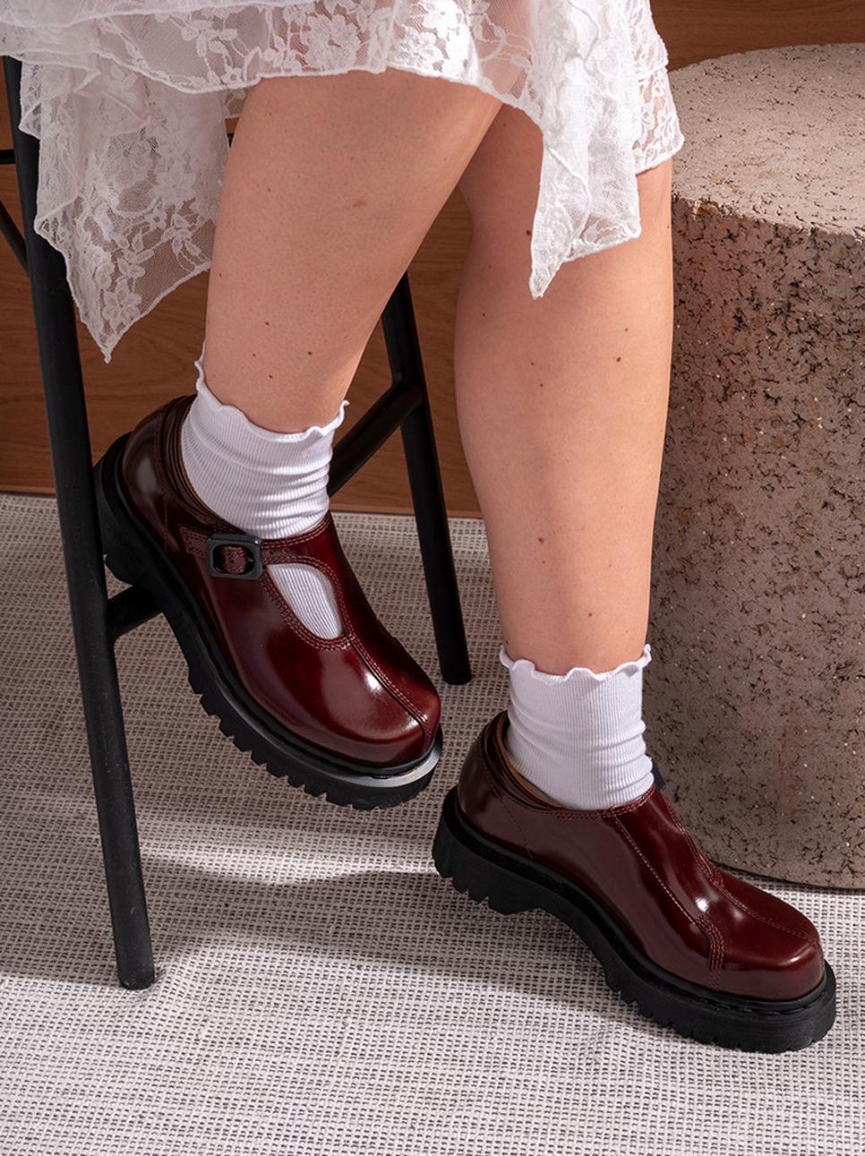 Woman wearing a white dress with Rejena Mary Jane leather shoes
