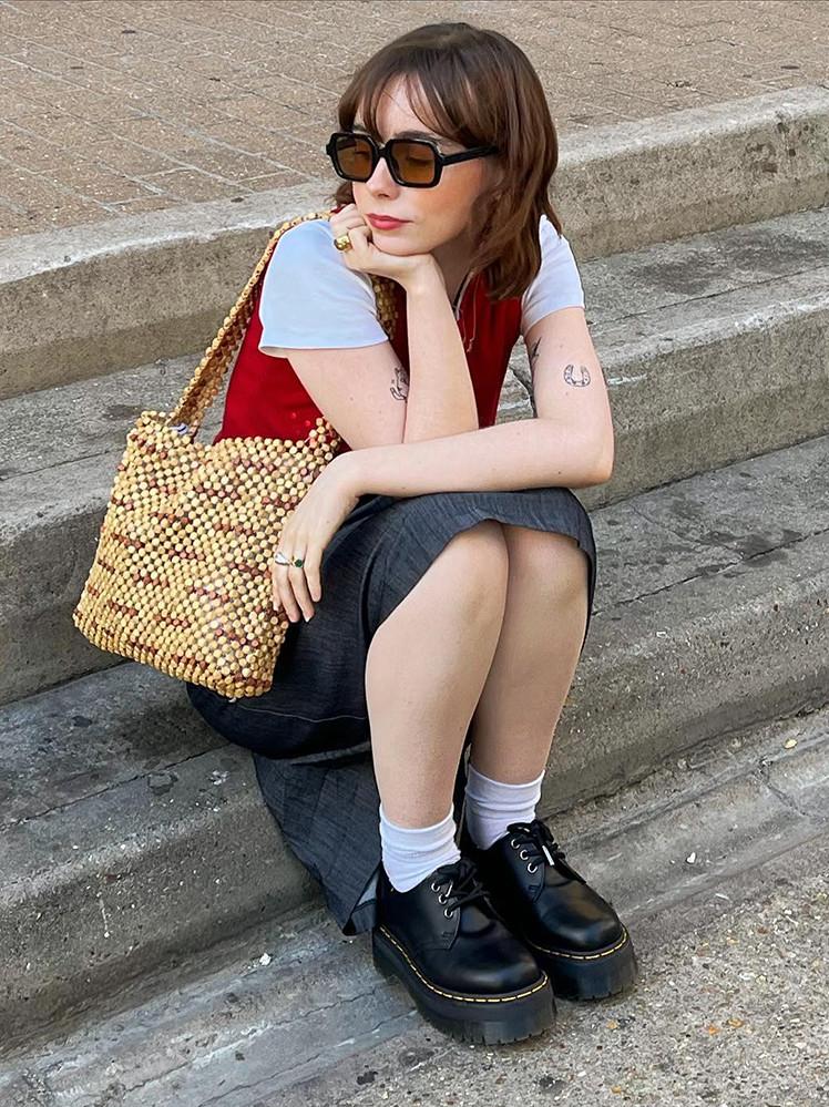 Woman wearing a dark skirt and 1461 oxford shoes