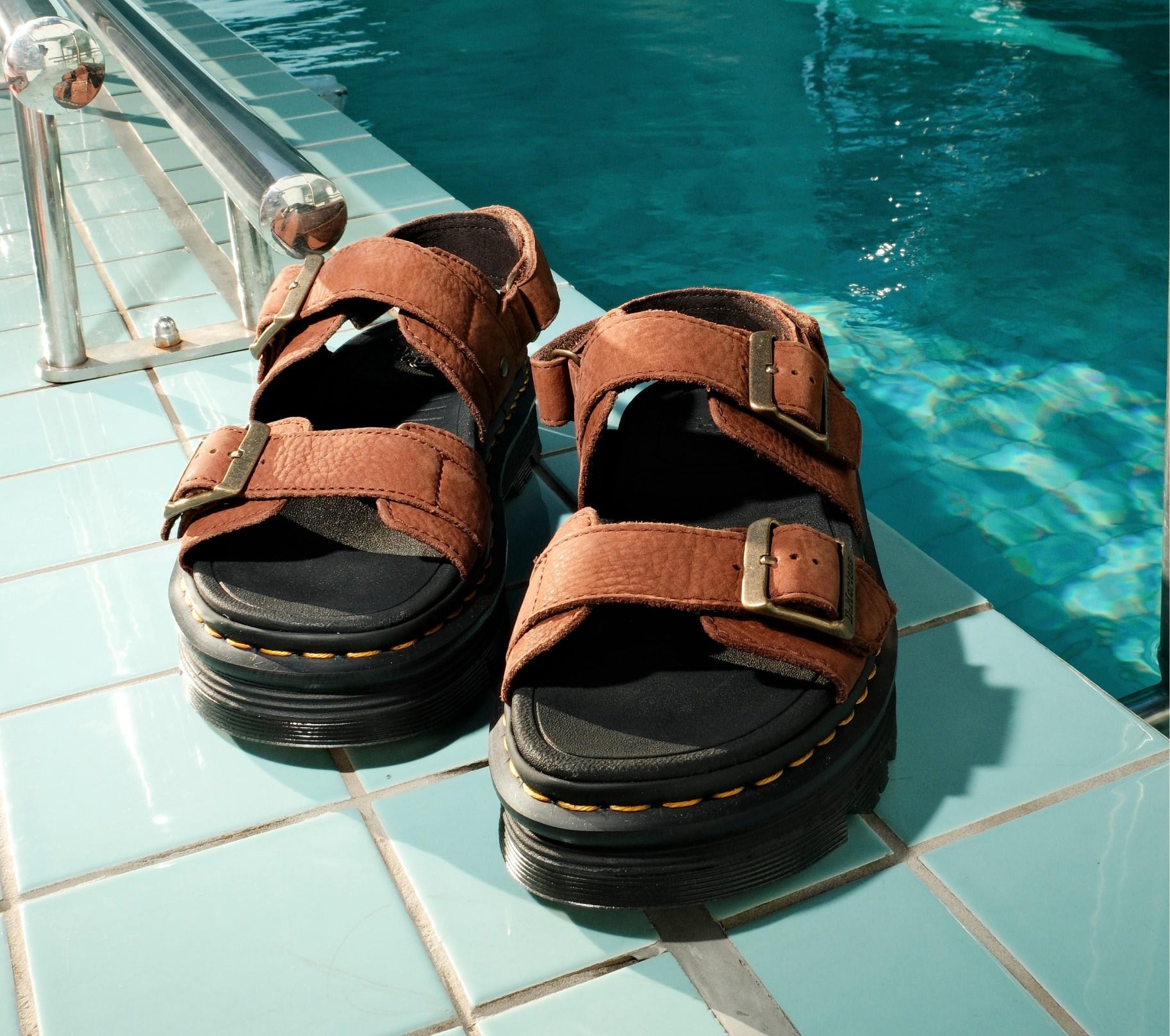 Dr. Martens Zebzag Nubuck Platform Sandals placed beside placed beside a swimming pool