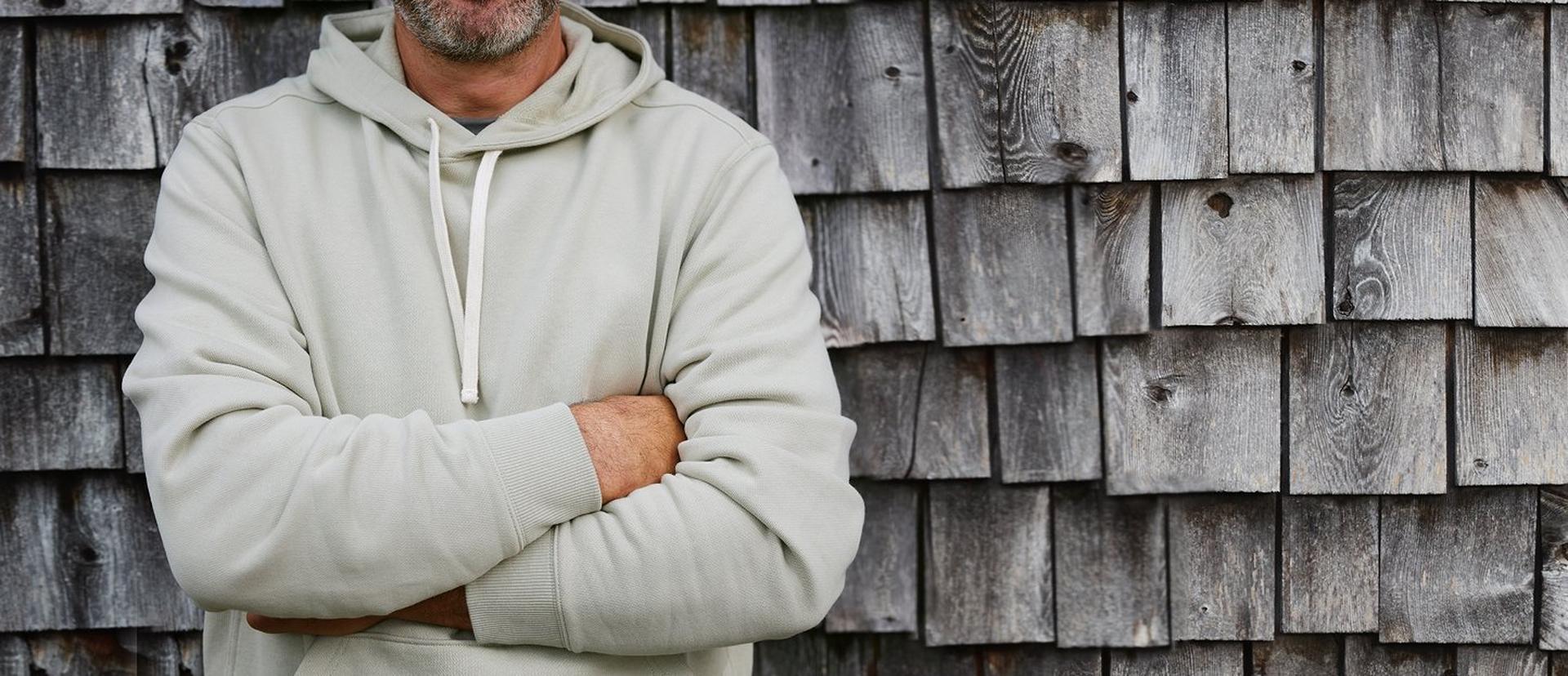 Man wearing a light tan hoodie.