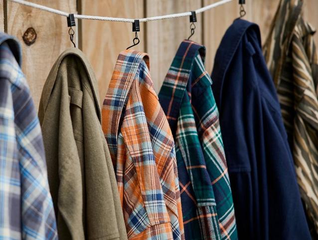 Flannel shirts hanging on a clothesline.  