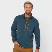 Man wearing a blue quarter zip shirt.