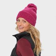 Woman wearing a pink pom beanie.