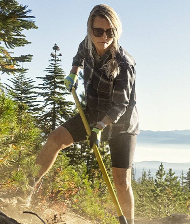 Woman wearing short digging into the ground while hiking in Washington