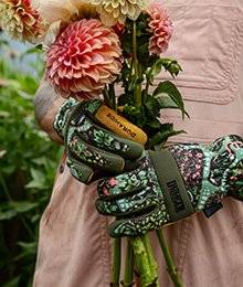 A close up of gardening gloves with a floral pattern