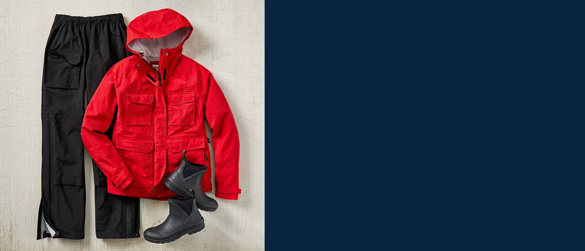 A pair of black rain pants, red raincoat and black rain boots
