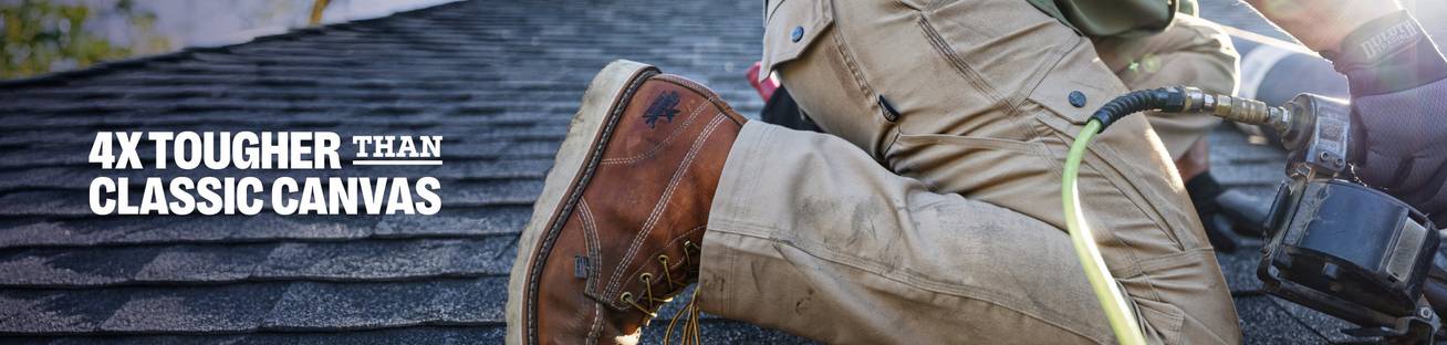 Headline: 4x Tougher than Classic Canvas. A man roofing in durable khaki colored pants.