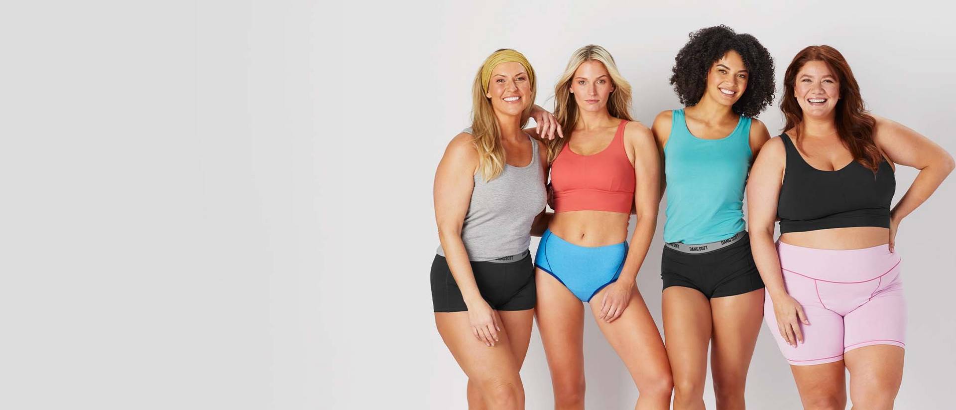 four women wearing a variety of duluth bras, tanks, and underwear