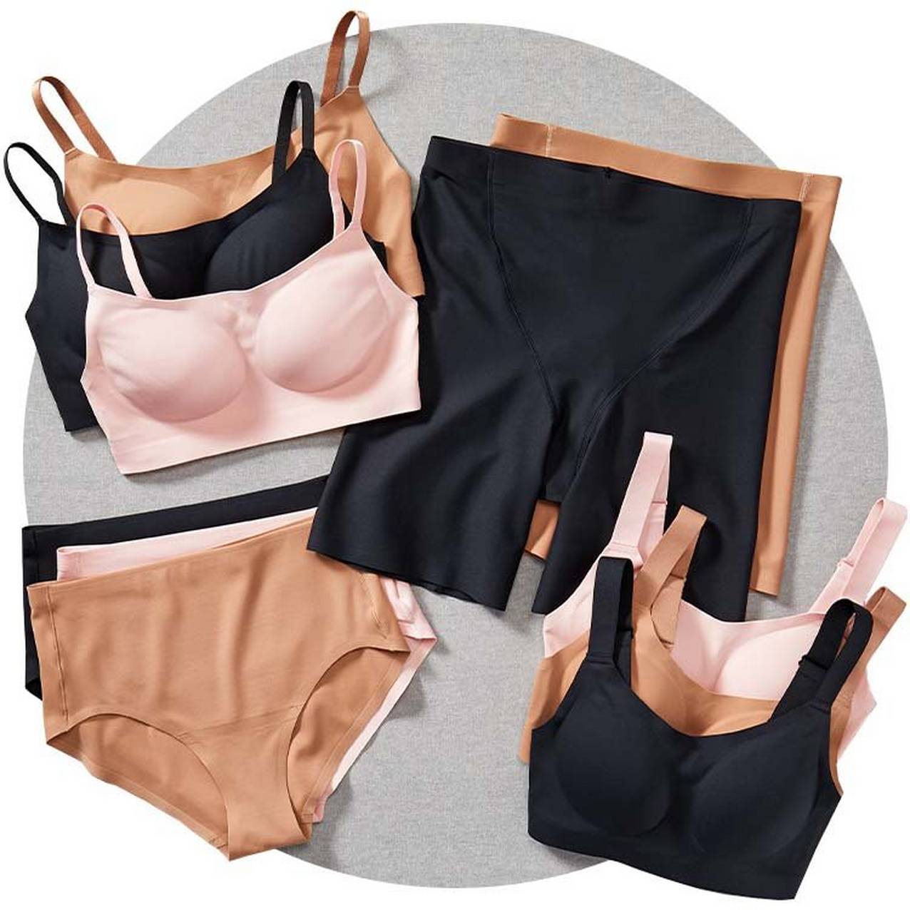 an array of women's line tamer bras, briefs, and boxer briefs in different colors