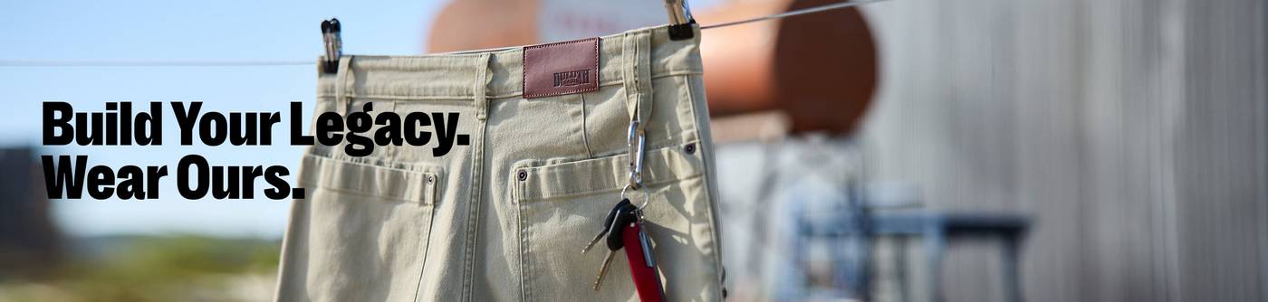 Headline: Build Your Legacy. Wear Ours. Fire Hose® Pants hanging on a clothesline.