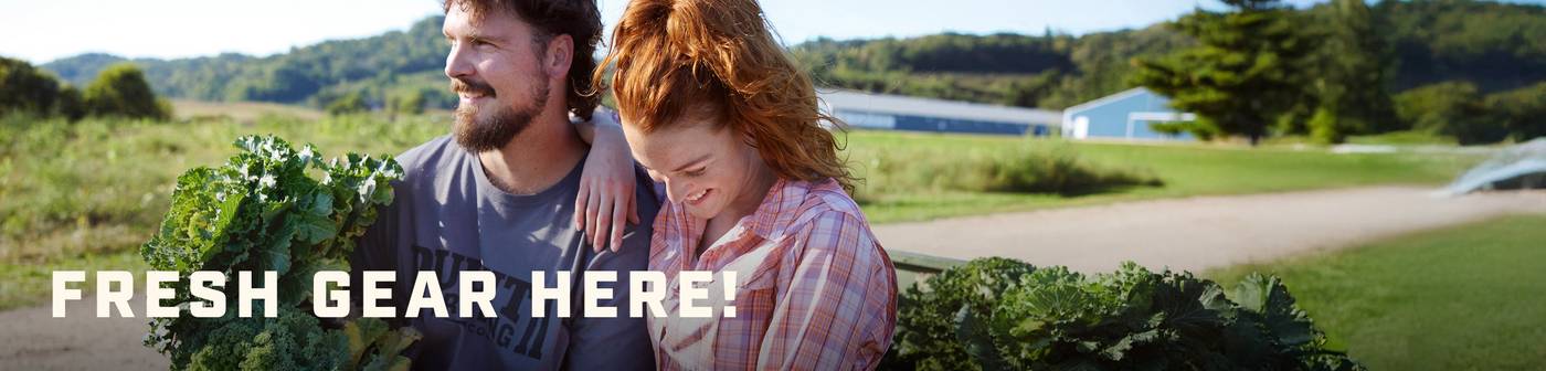 Headline: Fresh Gear Here! Man and woman carrying produce.