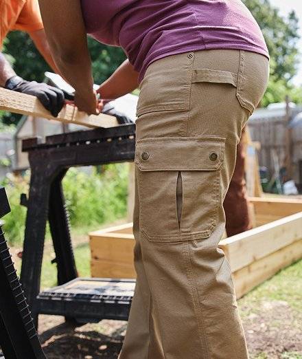Woman wearing tan work pants.