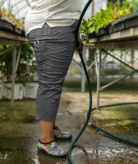 Woman wearing grey capri pants.