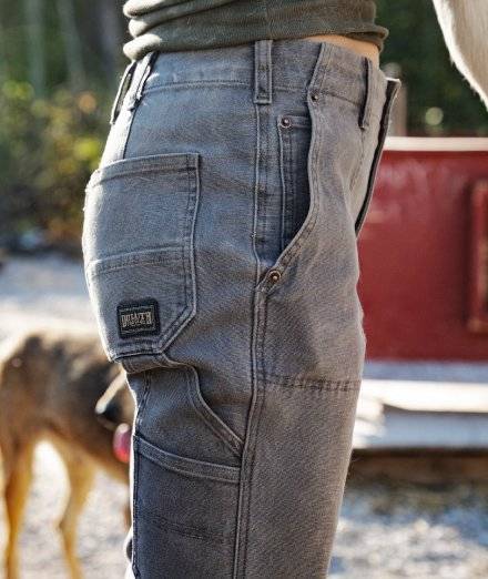 Woman wearing grey work pants.