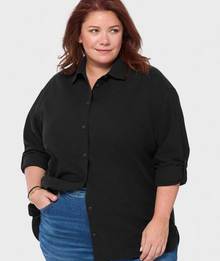 Woman wearing a black button down shirt.