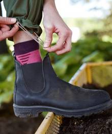Woman wearing black Chelsea boot.