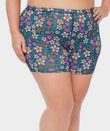 Woman wearing floral patterned boxer briefs.