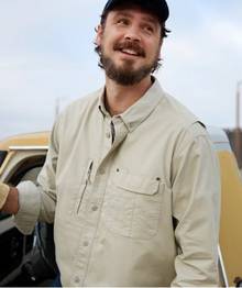 Man wearing a tan button-down shirt.