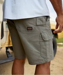 Man wearing olive green cargo shorts.