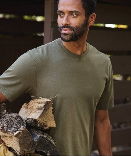 Man wearing olive green t-shirt.