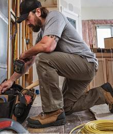 Man crouching in Fire Hose® Pants.
