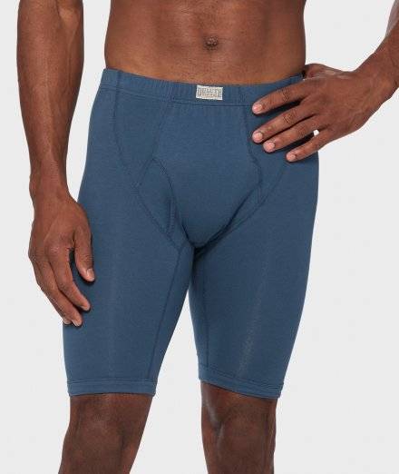 Man wearing long blue boxer briefs.