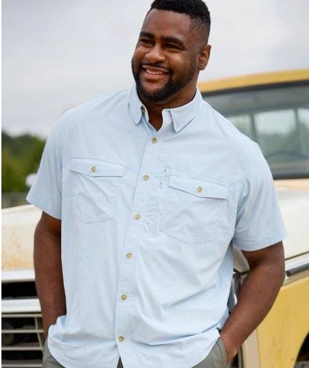 Man wearing a light blue short sleeve button-down shirt.
