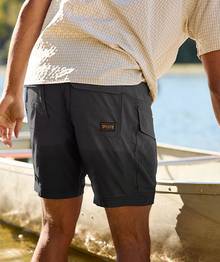 Man wearing grey shorts.