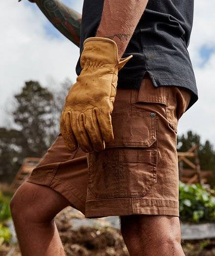 Man wearing tan cargo shorts.
