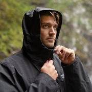 Man wearing black hooded rain jacket.