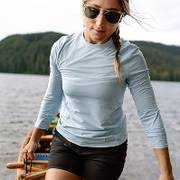 Woman wearing light blue long sleeve.