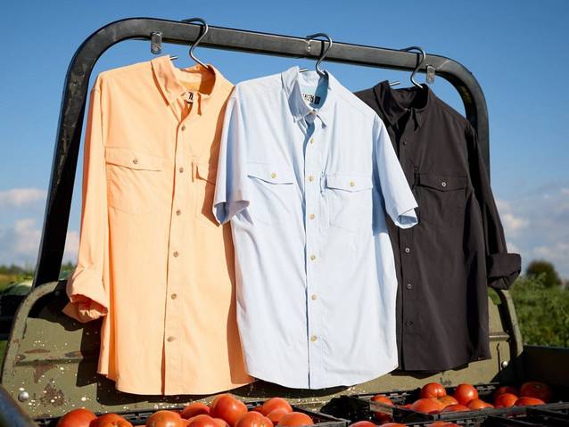 Three men's button-down shirts hanging outside.