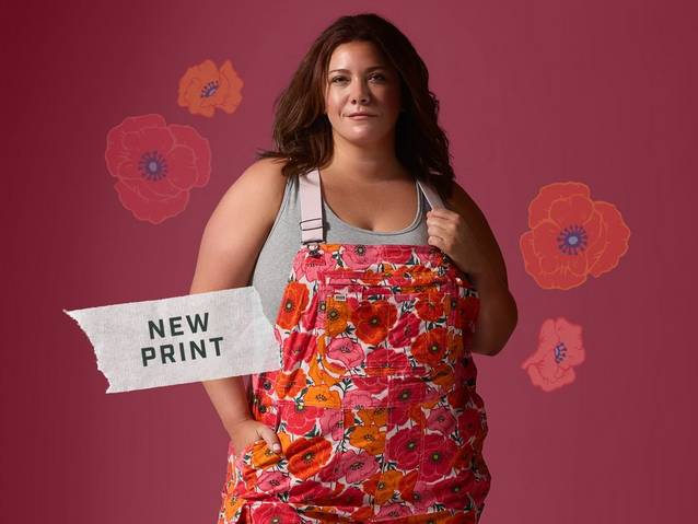 Woman wearing poppy patterned overalls.