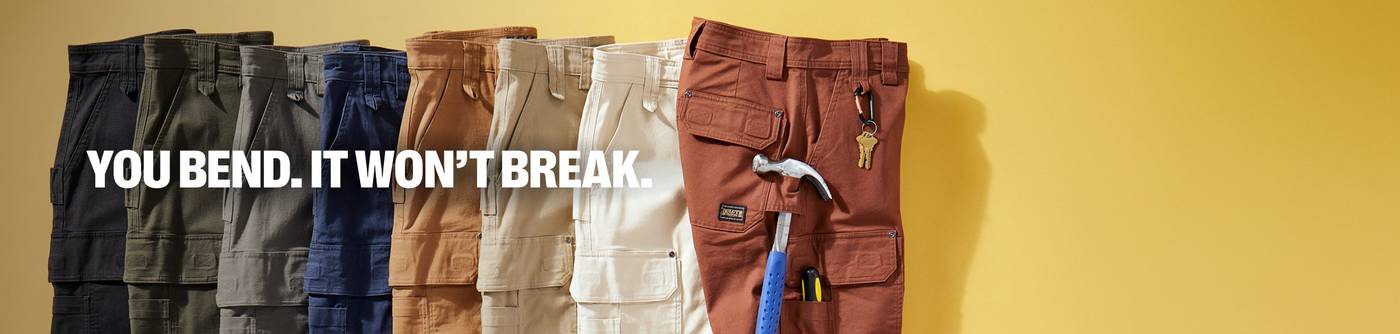 Headline: You Bend. It Won't Break. A stack of colored work pants with tools on a yellow background