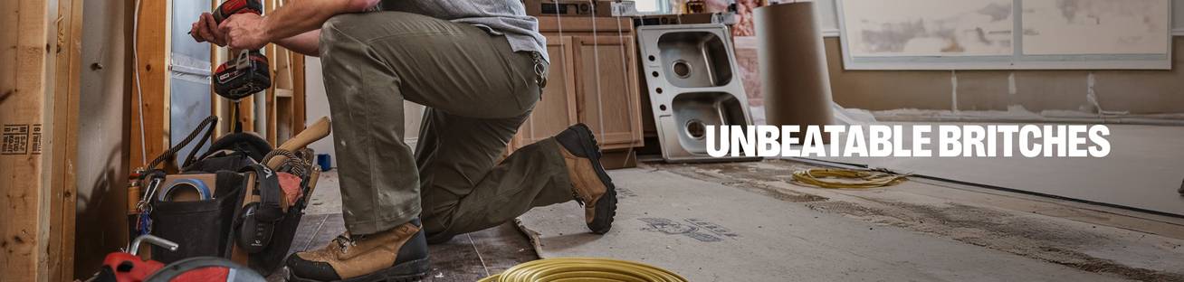 Headline: Unbeatable Britches. A man crouches in a construction site