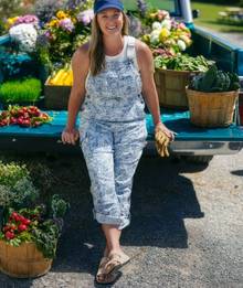 a woman wearing patterned overalls