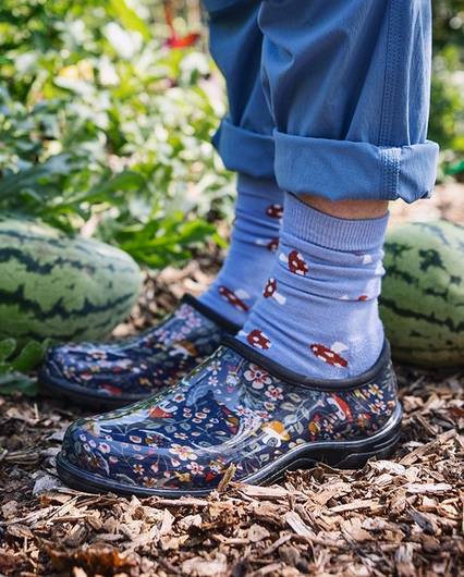 A close up of patterned garden clogs