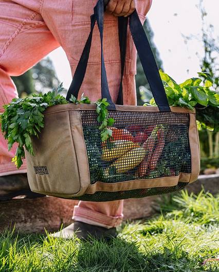 A close up of a garden bag filled with veggies