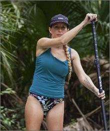 woman wearing akhg lost lake collection paddle boarding