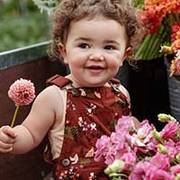 a little girl wearing kids' heirloom gardening bib overalls